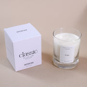 Amaraa Classic soy wax candle in glass jar with box on beige surface
